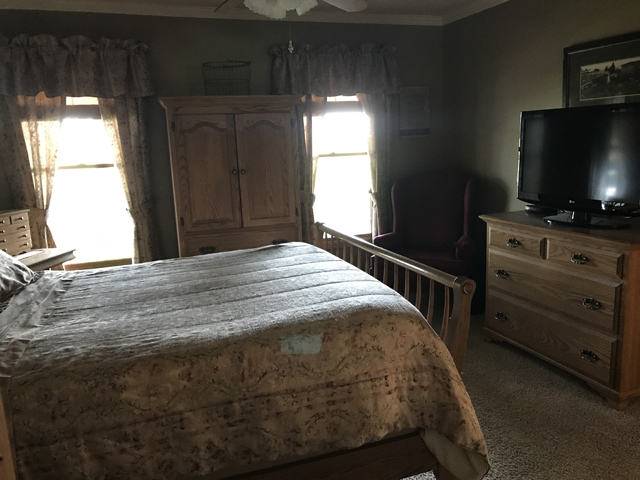 2115 East 875th Road Tonica, IL 61370 - Photo 17 of 41 a bedroom with a bed and a flat tv screen on dresser