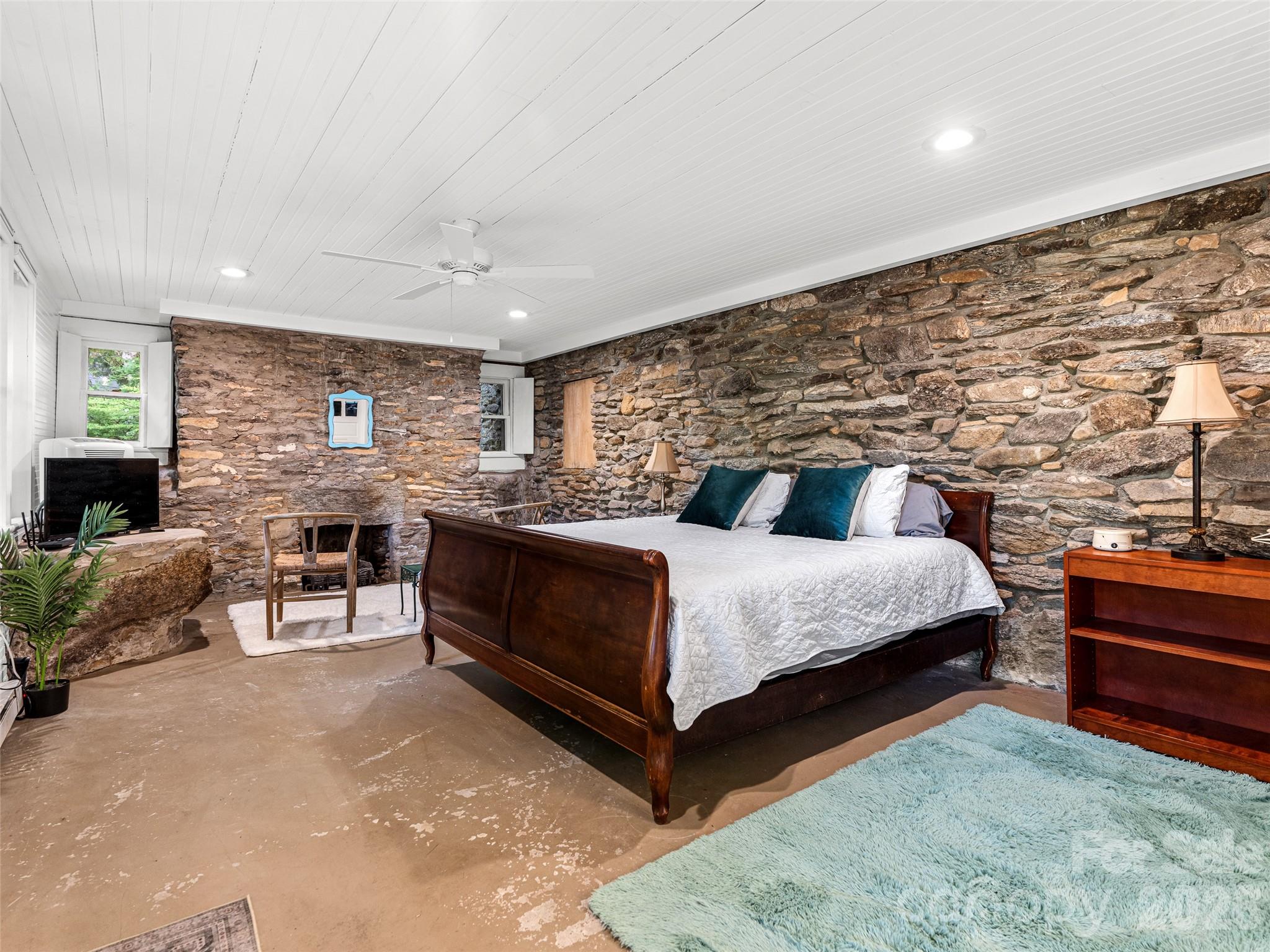 206 Chestnut Hill Road Gerton, NC 28735 - Photo 43 of 48 a bedroom with a bed and a fireplace