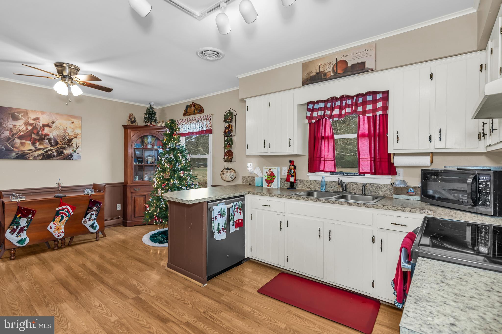 24383 Robins Creek Road Preston, MD 21655 - Photo 12 of 27 a kitchen with stainless steel appliances granite countertop a stove and cabinets