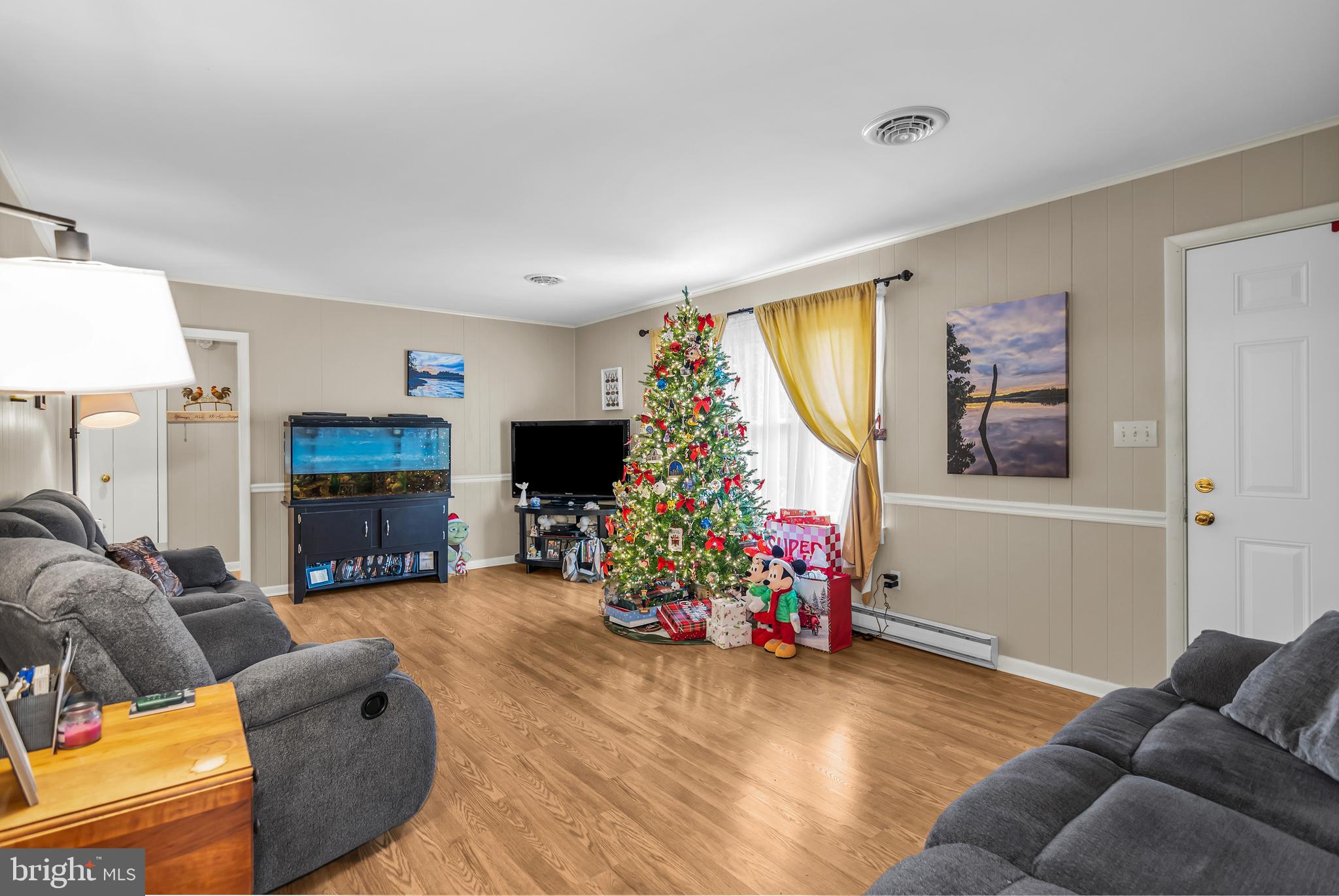 24383 Robins Creek Road Preston, MD 21655 - Photo 18 of 27 a living room with furniture fireplace and a flat screen tv