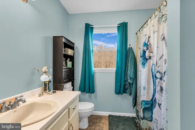 a view of bedroom with a bed and wooden floor