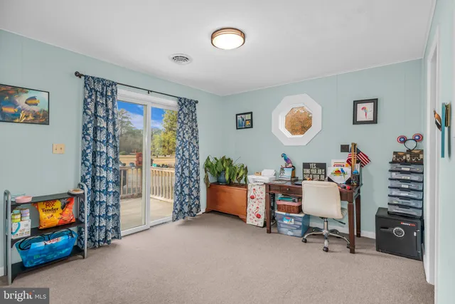 a children room with toys a ceiling fan and front door