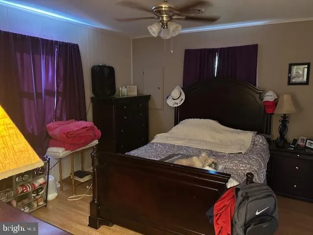 a bedroom with a bed and dresser with mirror
