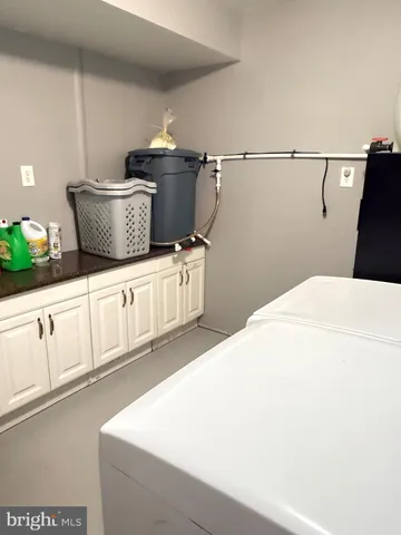 a close view of a sink and a refrigerator in a kitchen