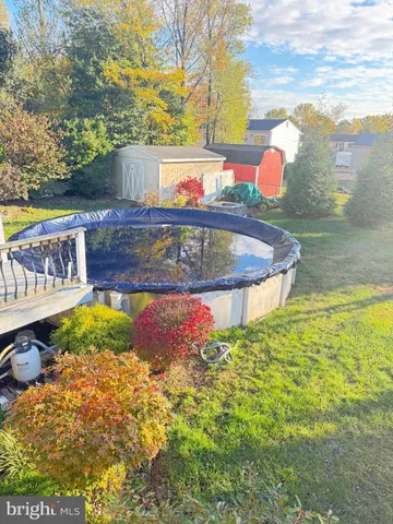 a view of a lake with a big yard and large trees