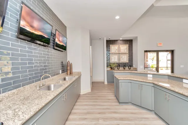 a large kitchen with kitchen island a sink stainless steel appliances and cabinets