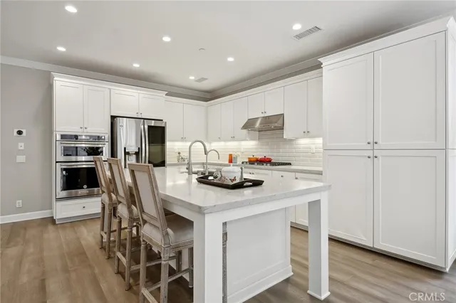 a kitchen with a sink a stove a microwave and cabinets