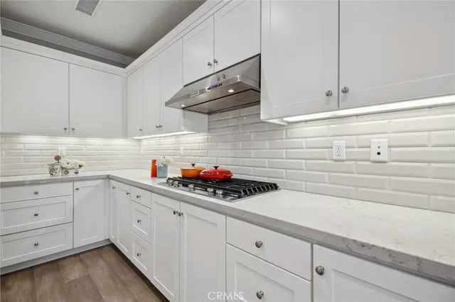 a kitchen with white cabinets and white appliances
