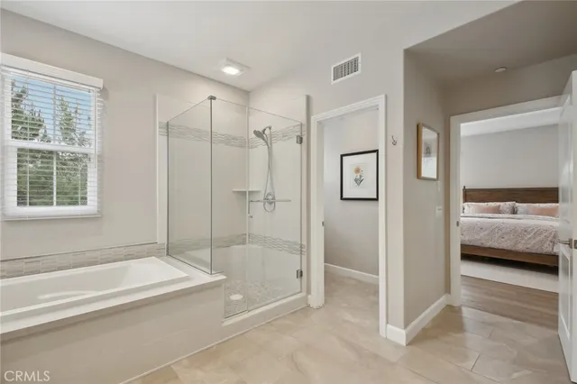 a bathroom with a tub shower and sink
