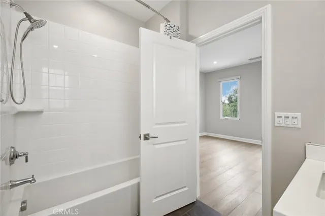 a bathroom with a bathtub and a shower