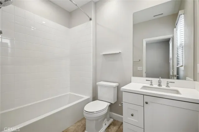 a bathroom with a sink toilet vanity and shower