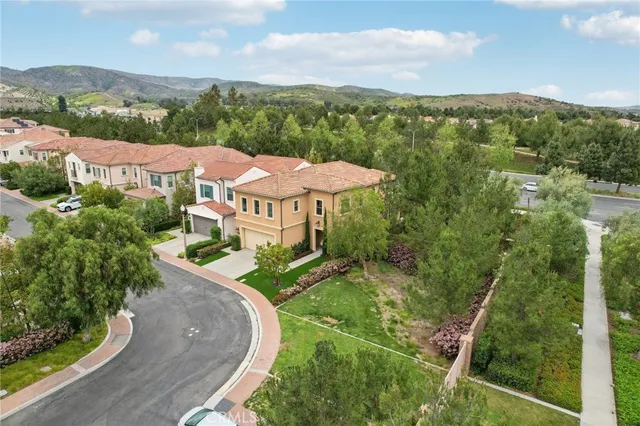 an aerial view of a house with yard