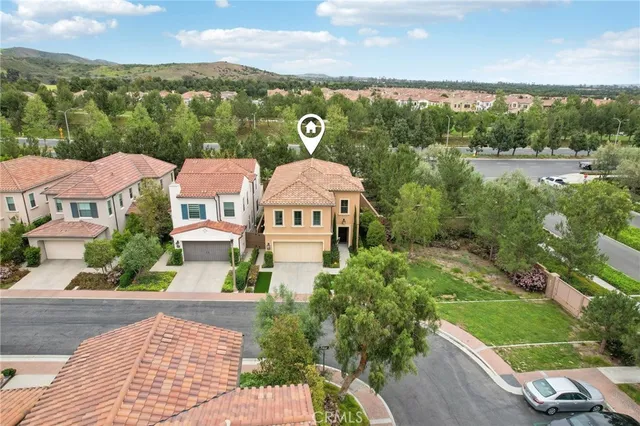 an aerial view of a house with yard