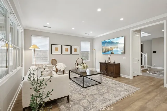 a living room with furniture and wooden floor