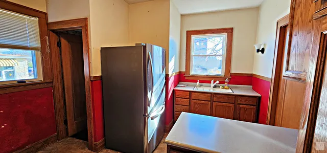a kitchen with stainless steel appliances granite countertop a refrigerator and a sink