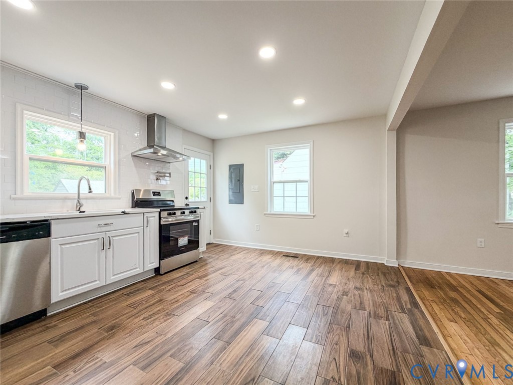 3409 Meadowbridge Road Richmond, VA 23222 - Photo 8 of 32 a kitchen with stainless steel appliances a stove top oven a sink a counter space and a window