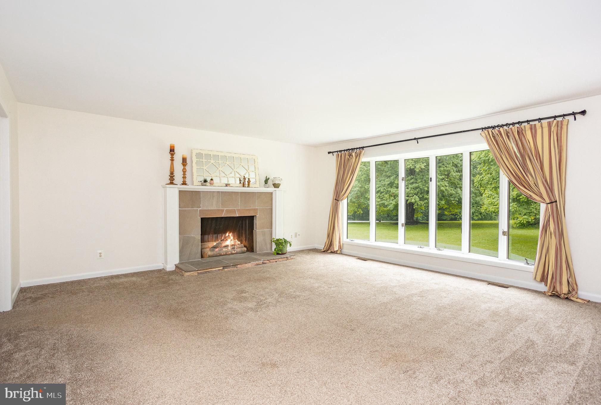 2007 Wilson Road White Hall, MD 21161 - Photo 18 of 41 a view of an empty room with a fireplace and a window