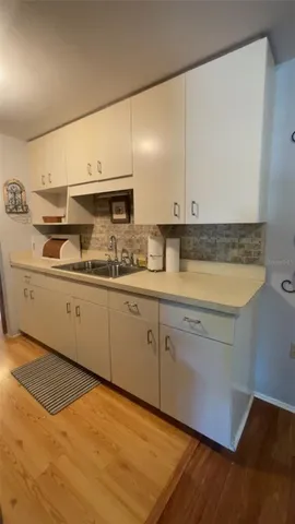 a bedroom with furniture and wooden floor