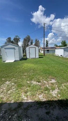 a view of a garden with a building in the background