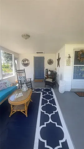 a living room with furniture and floor to ceiling window