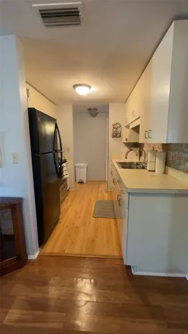 a kitchen with a refrigerator and a stove
