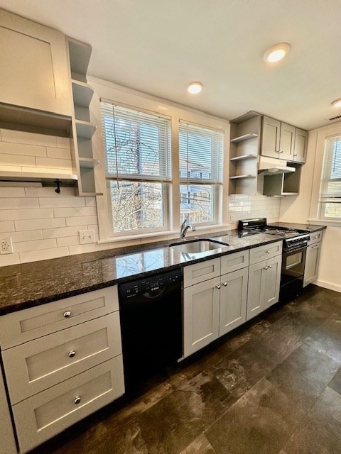 a kitchen with granite countertop stainless steel appliances a sink and cabinets
