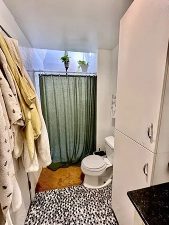 a bathroom with a toilet a sink and a shower