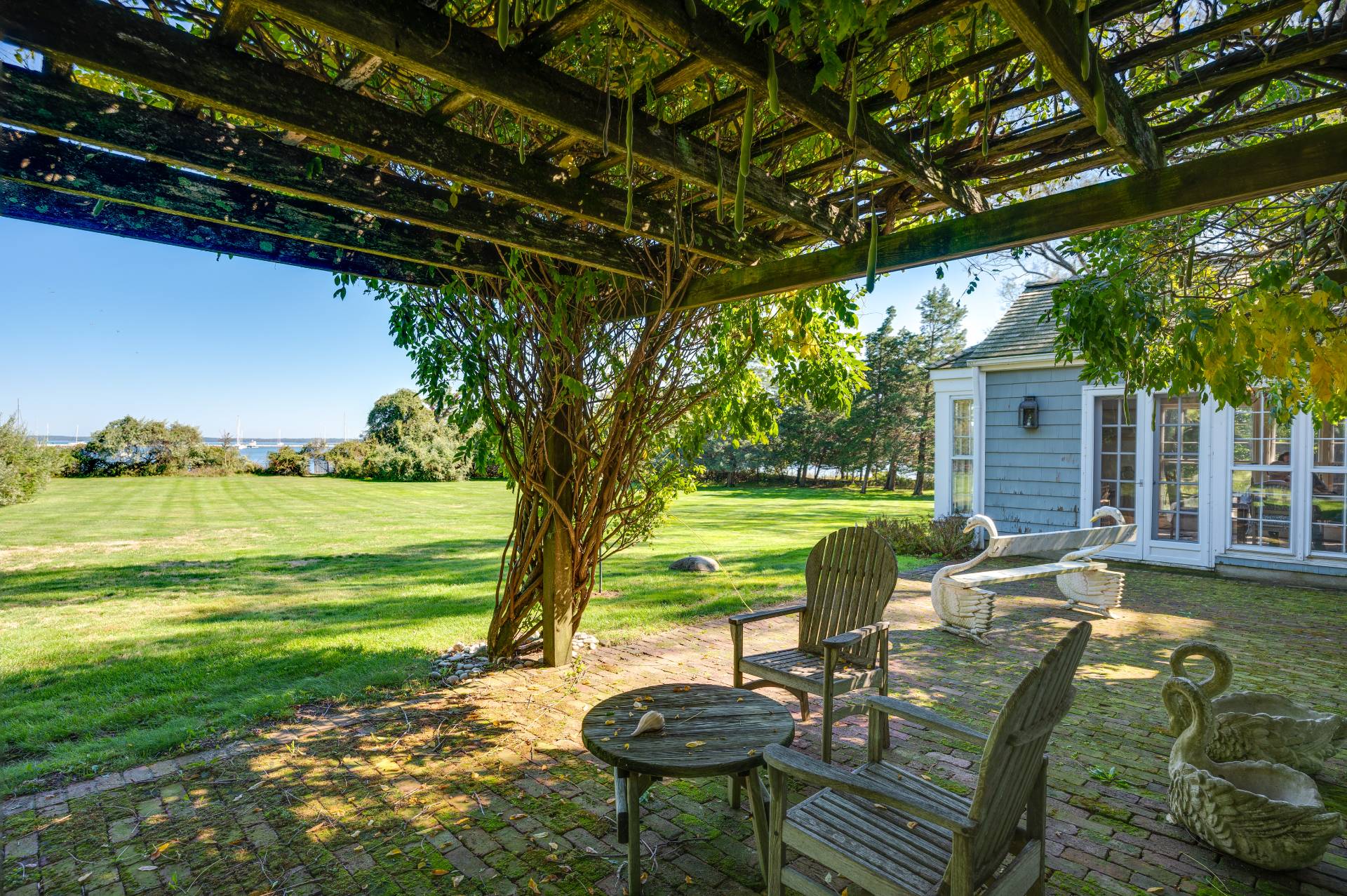 10 Ferry Road Sag Harbor, NY 11963 - Photo 15 of 41 a view of a swimming pool and lounge chairs in the patio