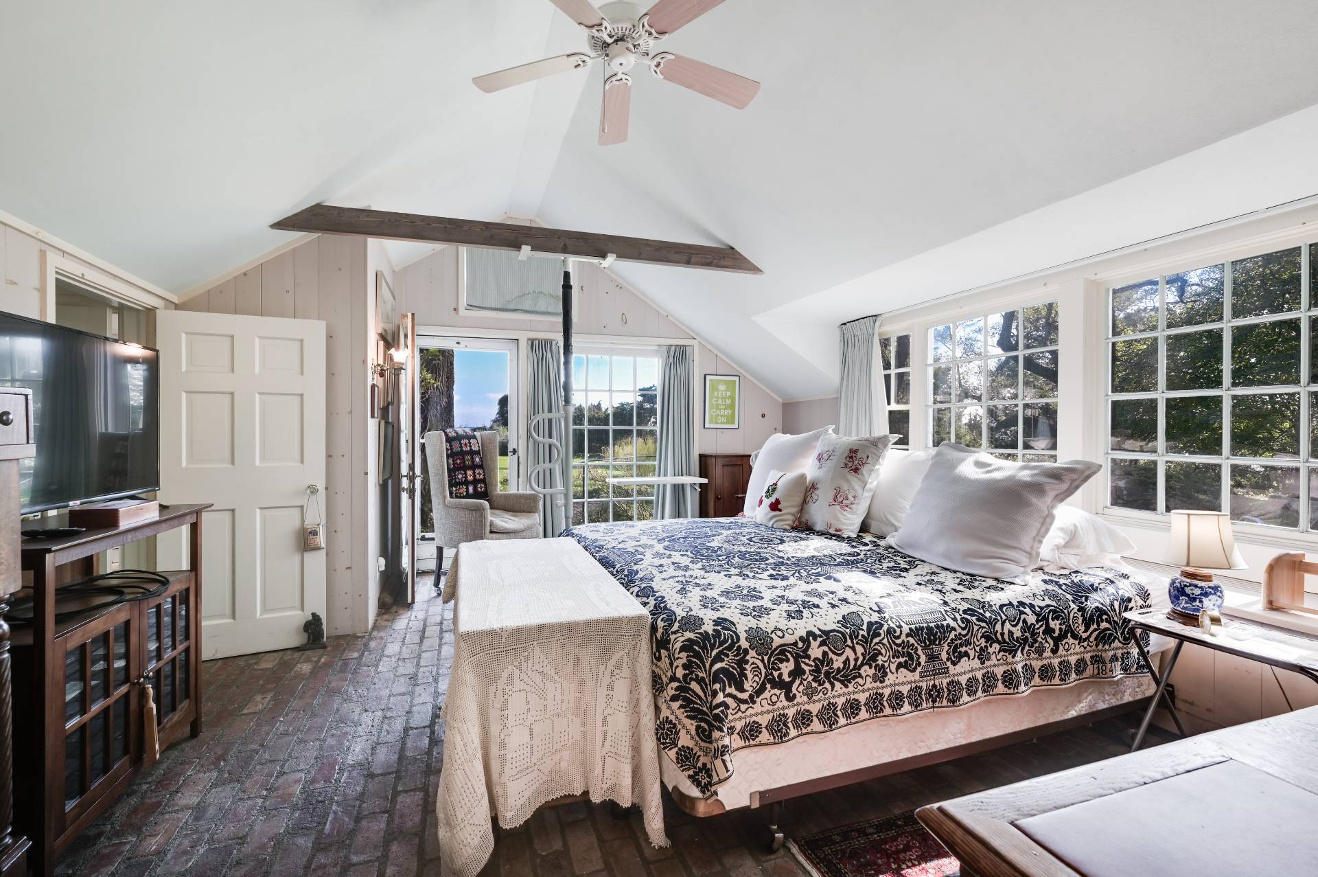 10 Ferry Road Sag Harbor, NY 11963 - Photo 34 of 41 a bedroom with a large bed and a flat tv screen