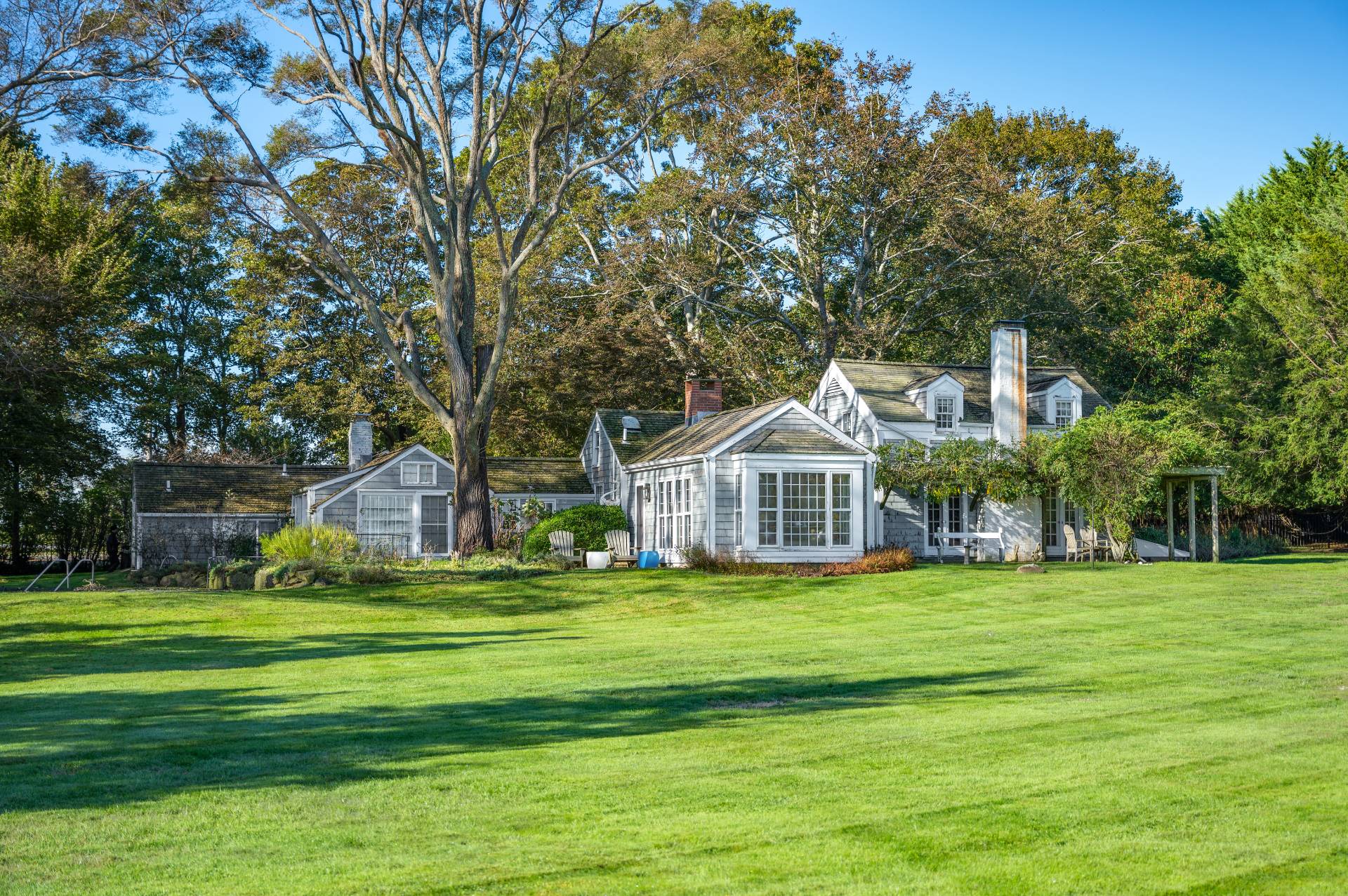10 Ferry Road Sag Harbor, NY 11963 - Photo 7 of 41 a white house with a big yard and large trees