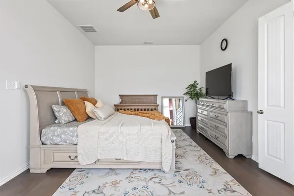 a bedroom with a bed and flat screen tv