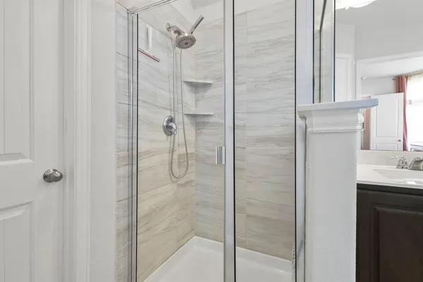 a bathroom with a shower and a sink