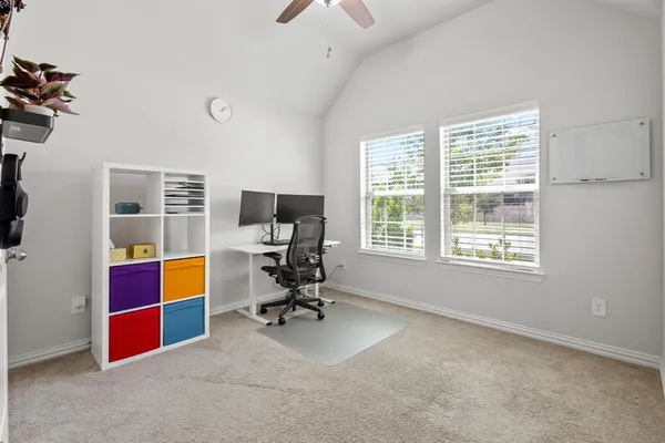 a view of room with workspace and windows