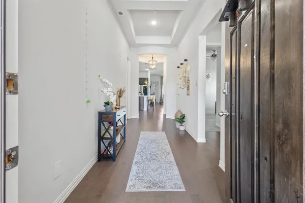 a hallway with a view of living room