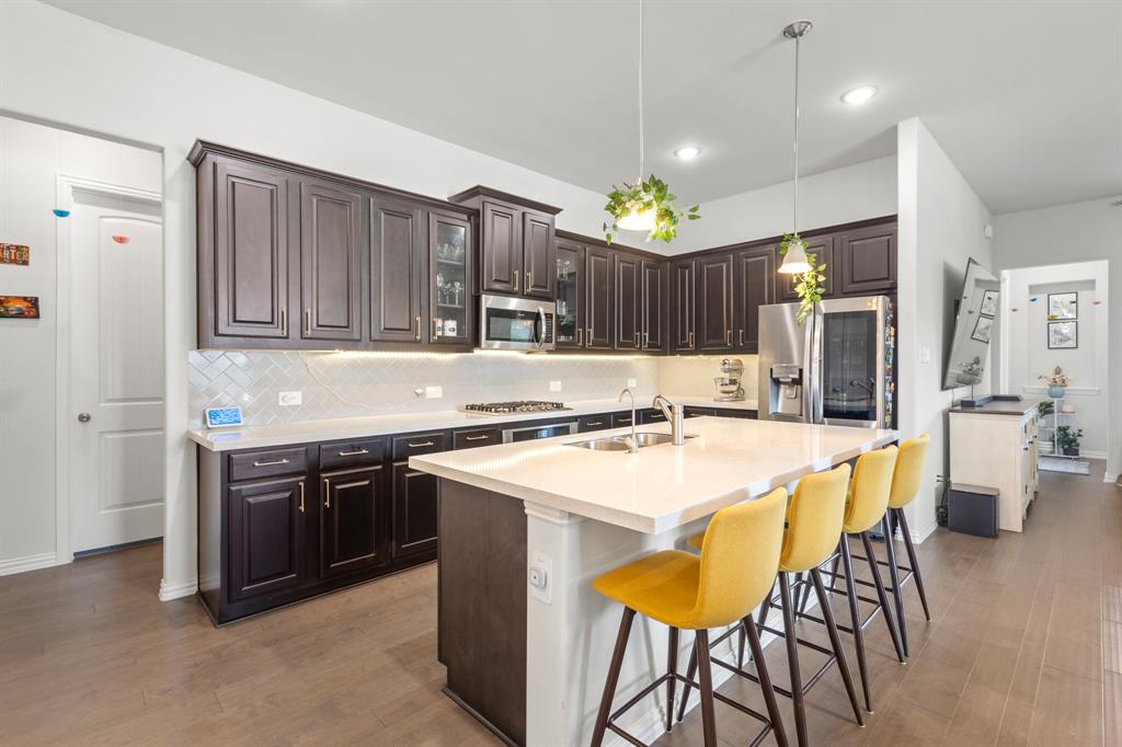 448 LeTara Ranch Drive Haslet, TX 76052 - Photo 6 of 32 a kitchen with a stove a refrigerator and a dining table