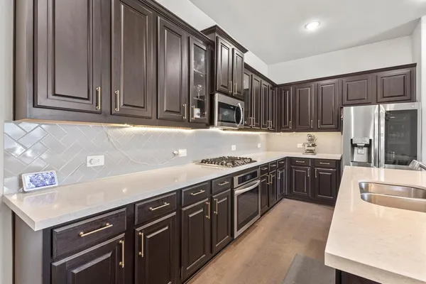 a kitchen with a stove a sink and a refrigerator