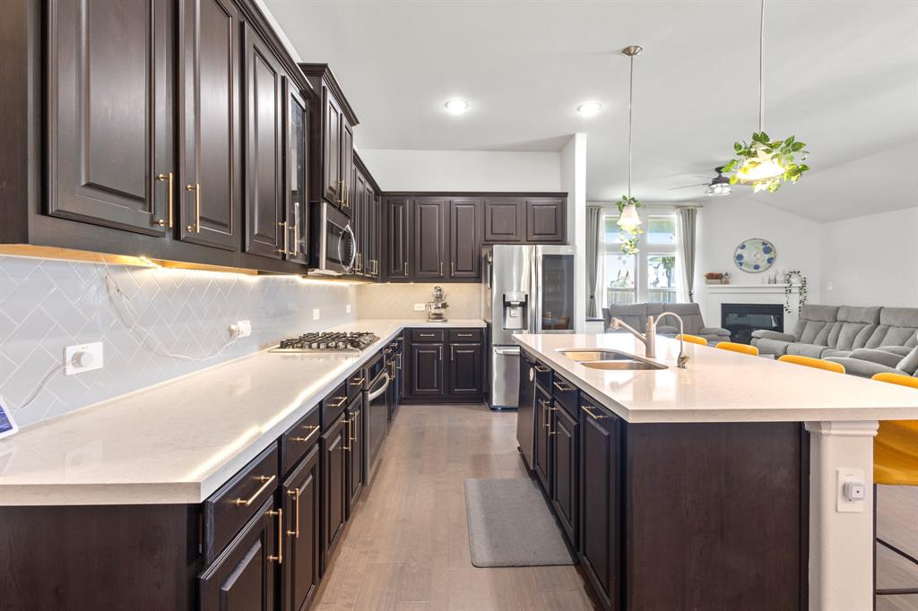 448 LeTara Ranch Drive Haslet, TX 76052 - Photo 8 of 32 a kitchen with kitchen island granite countertop stainless steel appliances a sink stove and cabinets