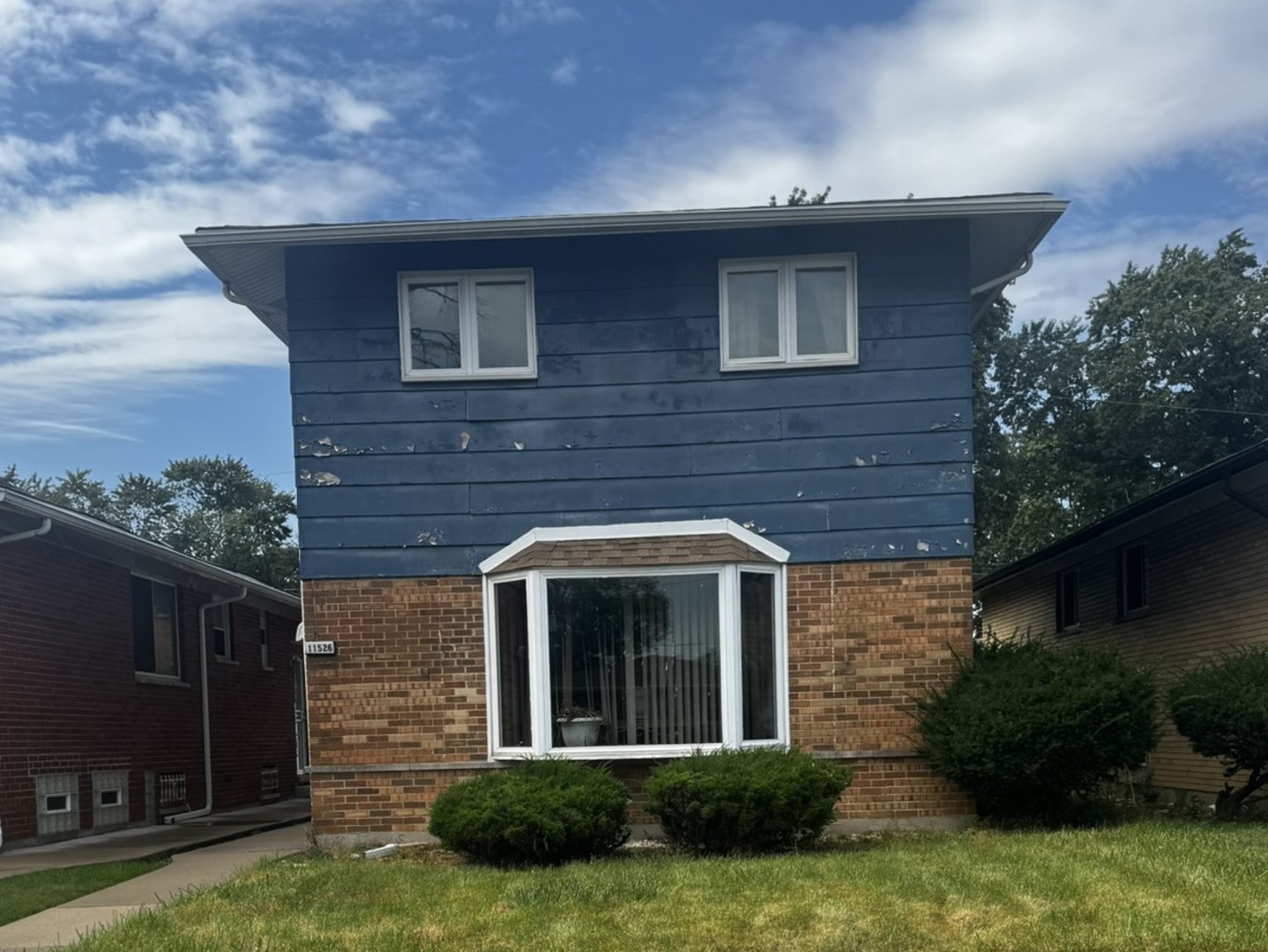 a front view of a house with a yard