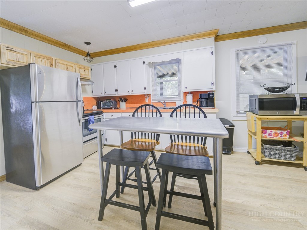 1471 Bamboo Road Boone, NC 28607 - Photo 7 of 19 a garage with a table and a refrigerator