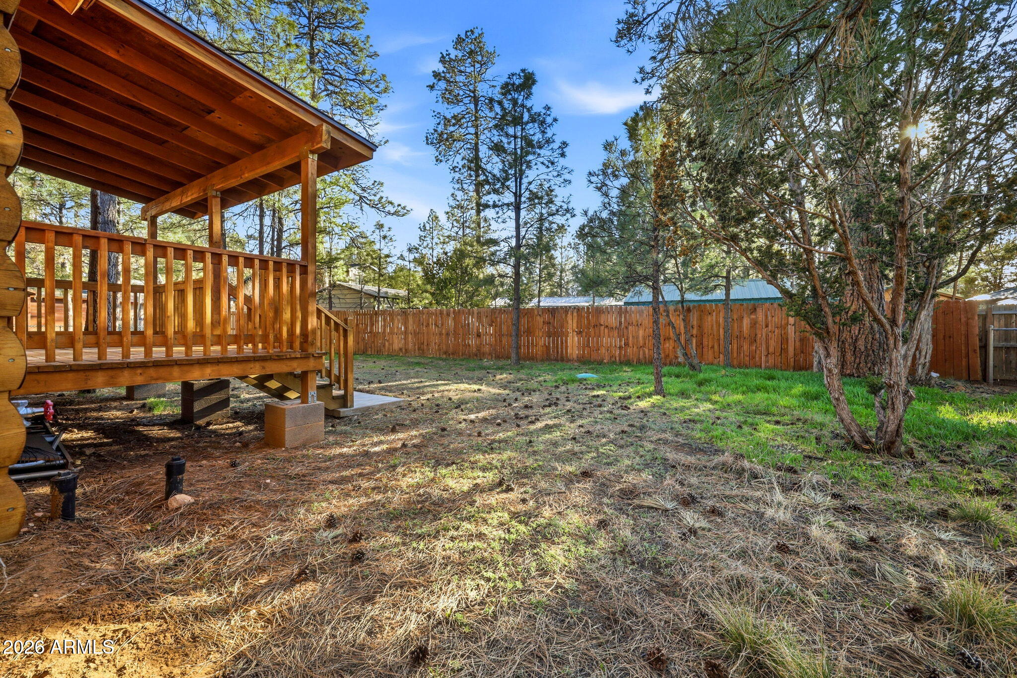 2900 Long Rifle Place Overgaard, AZ 85933 - Photo 27 of 35 a view of backyard with large tree and wooden fence