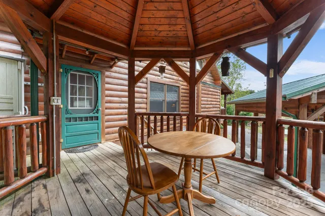a view of a wooden table and chairs in the balcony