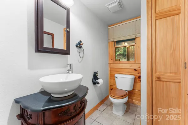 a bathroom with a toilet a sink and a mirror