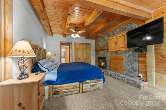 a living room with furniture a flat screen tv and kitchen view