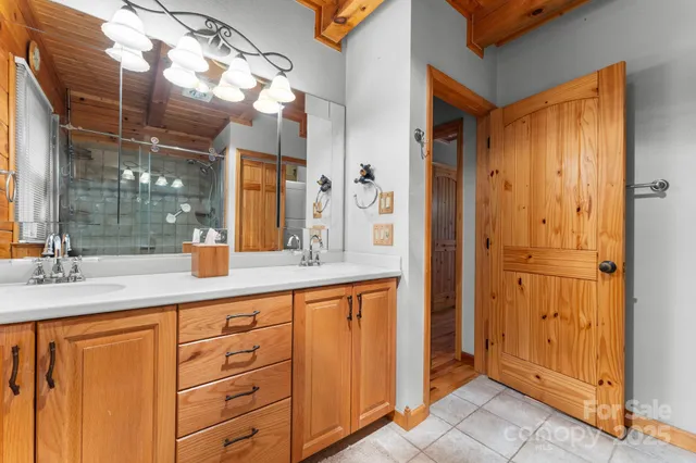 a bathroom with a granite countertop sink mirror and