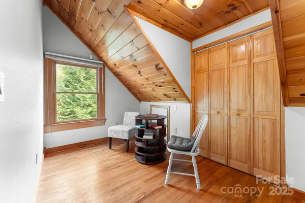 a living room with a bed and a window