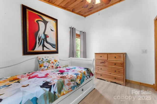 an empty room with windows and fireplace