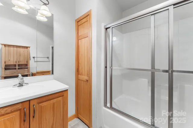 a view of an empty room with a fireplace and a window
