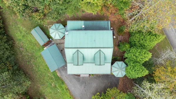 an aerial view of a house with a yard