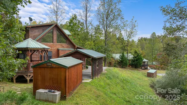 a view of a deck with a table and chairs next to a yard