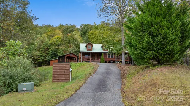 a view of a street with potted plants and large trees